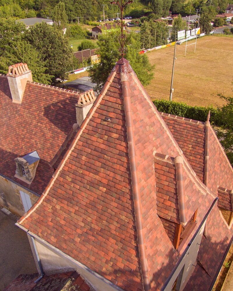English & French Country Roof Style Steep-pitched English and French country roof with aged clay tiles in blended tones.
